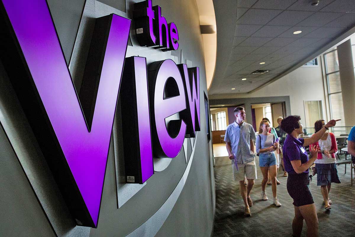 Student tour passes The View dining hall sign